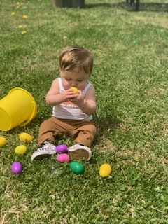 A baby sitting on easter eggs